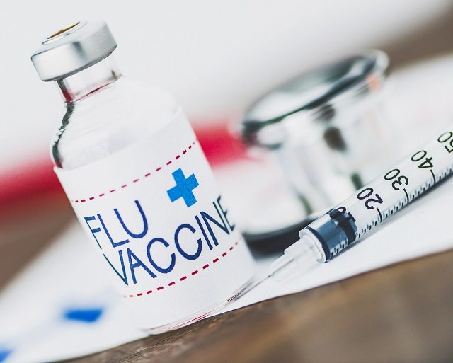 Flu vaccine with syringe and stethoscope flu vaccine, is flu vaccine safe, is flu vaccine safe when pregnant, who should get the flu vaccine, HSE, is the flu jab safe, how much is the flu vaccine, who should get the flu vaccine