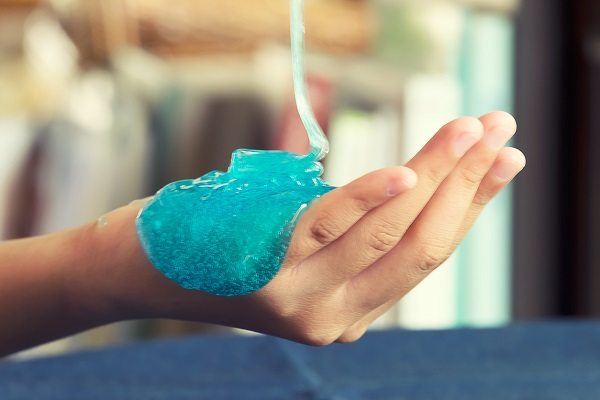 Kid Playing Hand Made Toy Called Slime Alian